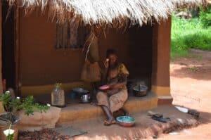 African mother feeding a child in Zambia