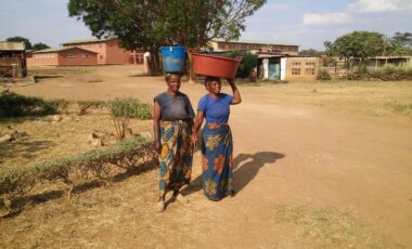 women carrying buckets