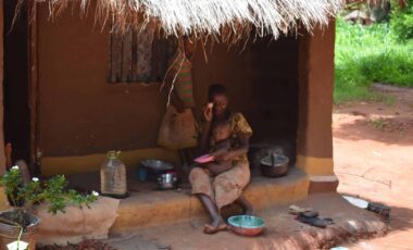 African mother feeding a child in Zambia