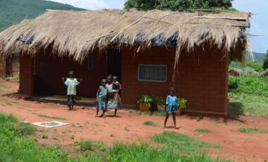 African hut with children